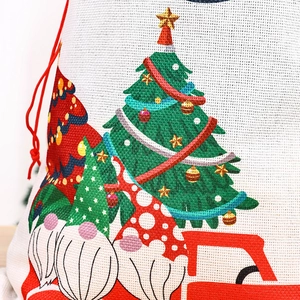 Detail of Christmas burlap drawstring bag with gnome print and festive textures