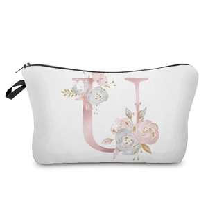 Close-up of elegant watercolor floral letter U print on white canvas makeup bag