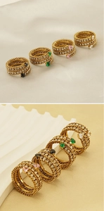 Detail of 18k gold plated multi-layer rings with heart-shaped gems and braided texture