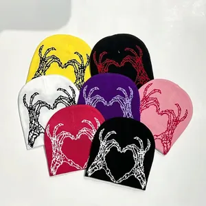 Knitted beanie featuring heart-shaped skeleton hands pattern in various vibrant colors