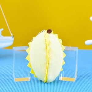 Detailed view of a soft yellow plush durian keychain pendant for bags and keys