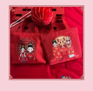 Detail of red wedding canvas gift bag featuring a cartoon bride and groom illustration
