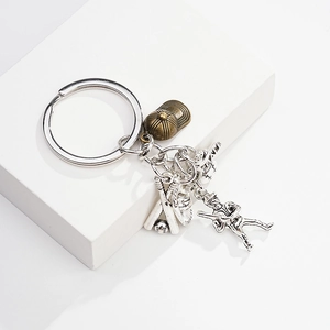 Detailed close-up of baseball themed metal keychain with glove and bat pendants