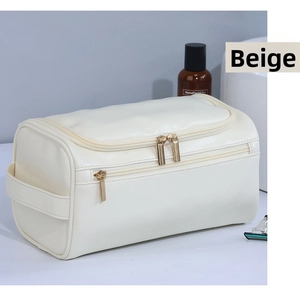 Dettaglio beauty case grande in pelle PU beige con cerniere dorate e doppio scomparto