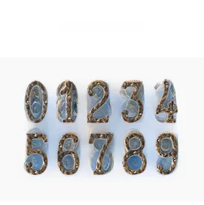 Macro detail of industrial cast iron wall numbers 0-9 with rustic bronze finish