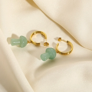 French style 18K gold C-shape earrings with light green mushroom pendants on beige silk