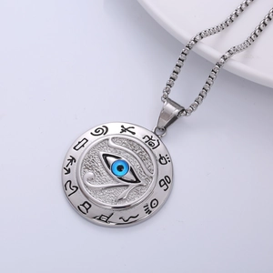 Macro shot of silver Eye of Horus pendant with blue eye inlay on white ceramic background