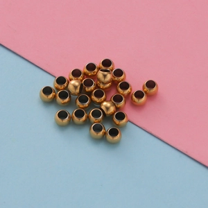 Polished golden hollow 3x4mm stainless steel beads for DIY jewelry making on dual background