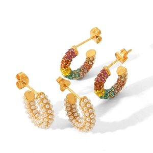 Golden C-shaped earrings with pearls and colorful crystals on a white background