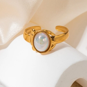 Close-up of a vintage gold ring featuring a colorful oval gemstone on a white pedestal