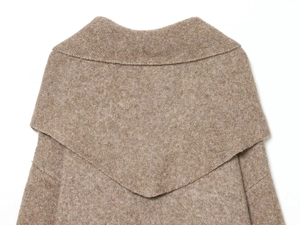 Detailed close-up of brown wool knit sweater collar with plush layered texture
