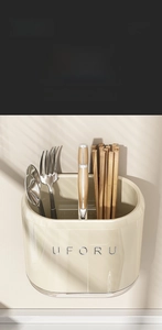 Macro shot of dual-compartment beige kitchen cutlery holder for organized utensil storage