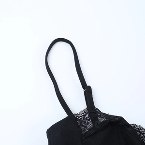 Detailed close-up of delicate black lace trim and adjustable strap on a camisole top