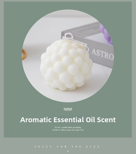 Detail of white bubble scented candle with textured surface and small hanging tag