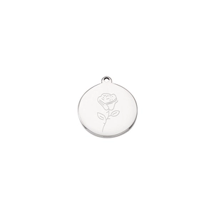 Macro shot of silver stainless steel round pendant with rose pattern line engraving