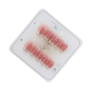 Handmade light pink gradient press-on nails with silver glitter edges and small rhinestones