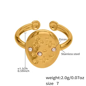 Macro detail of 18k gold plated stainless steel ring with star engraving and white zircons