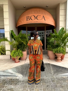 Close-up of African print two-piece set featuring abstract patterns and striped ribbon detail