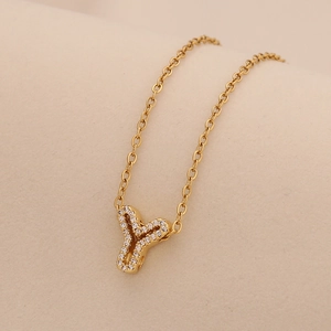 Detailed close-up of gold Y letter pendant with clear zircon on a delicate chain