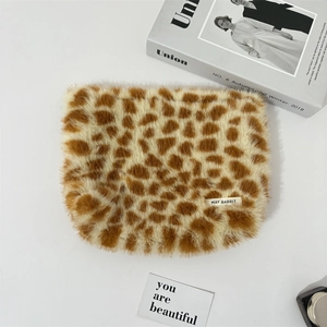 Detail shot of plush leopard print makeup bag featuring high-quality faux fur material