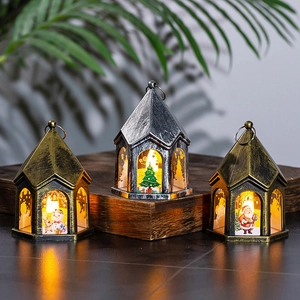 Miniature vintage Christmas lanterns with warm LED lights on rustic wood base