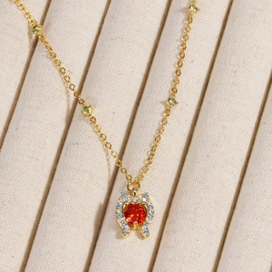 Elegant gold necklace with heart-shaped red zircon and colorful gemstone accents