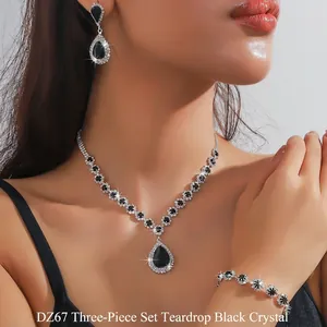 Detail view of model wearing silver necklace set with black teardrop crystal pendants