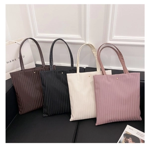 Detailed row of pleated tote bags in four colors showing vertical textured PU leather
