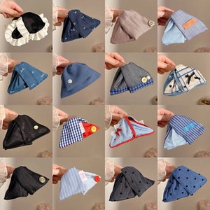 Detailed grid of diverse fabric hair clips featuring stripes, plaid and pearl accents
