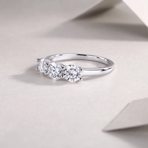 Macro detail of silver S925 ring featuring three sparkling round moissanite stones