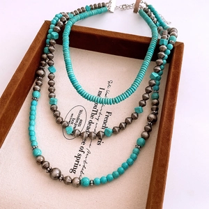 Macro detail of triple-layer vintage stone beads necklace with turquoise and silver finish