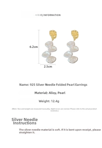 Detail view of long baroque pearl earrings with pleated gold alloy and 925 silver needles