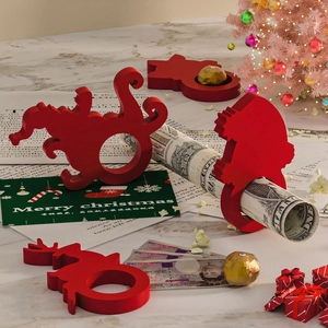 Red Christmas napkin ring set with elk and Santa shapes on a marble festive table