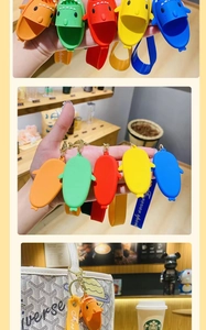 Detail of colorful mini shark slipper keychains with matching wrist straps and gold clasps