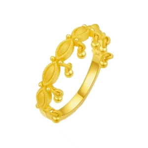 Vintage golden ring featuring delicate beaded texture and tassel charm on a white background