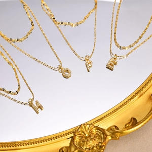 Double-layered golden stainless steel letter necklace with sparkling crystal charms