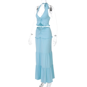 Detail of light blue two-piece set featuring halter neck top and ruffled maxi skirt