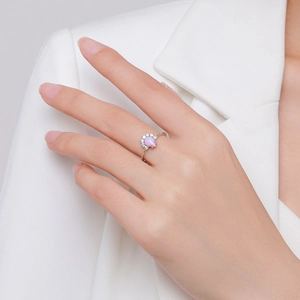 Elegant S925 sterling silver ring with pink pear-shaped opal on a woman's finger