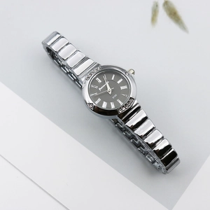 Close-up of Roman dial with crystal accents and luxury silver metal strap of women watch