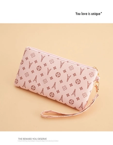 Detail of pink PU leather long clutch wallet featuring vintage embossed floral patterns
