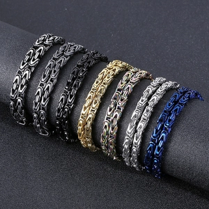 Close-up of 6mm stainless steel Byzantine chains in multiple colors on a black display stand