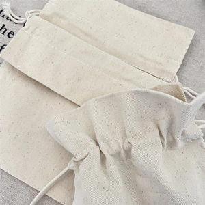 Close-up of eco-friendly beige canvas drawstring pouch with natural cotton rope detail