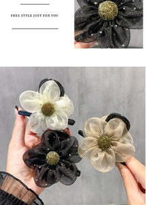 Macro detail of elegant mesh flower hair clips with sparkling rhinestones in three colors