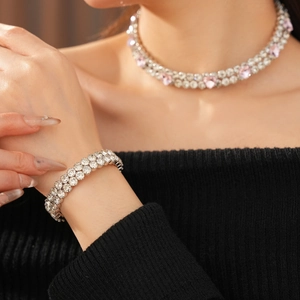 Détail d'un ensemble de choker et bracelet argenté multicouches avec cristaux roses