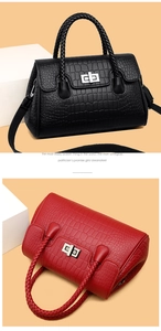 Detail of embossed leather handbag with woven handles and silver twist lock closure