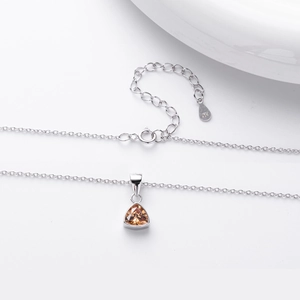 Detailed macro of S925 sterling silver stamp and champagne triangle gem pendant