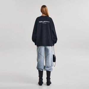Rear view of oversized black long-sleeved cotton T-shirt with white SMFK brand logo print