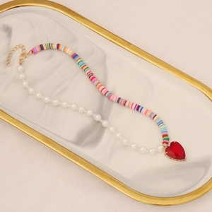 Bohemian pearl and colorful heishi bead necklace with a large red heart pendant
