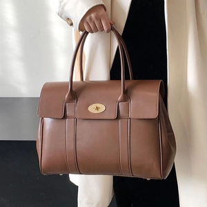 Classic caramel brown leather tote bag with elegant metallic clasp for daily commute