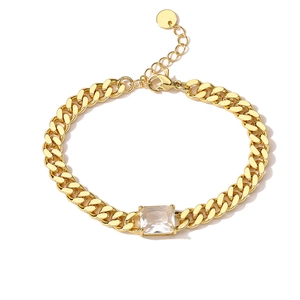 Detail of 18K gold plated curb chain bracelet featuring a square cut cubic zirconia stone